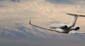 A plane flying through the sky with clouds